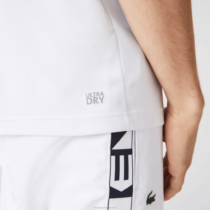 hombres Lacoste 6F24556 blanco azul marino 5yp Polo deportivo de tenis de piqué resistente a las carreras de ajuste regular
